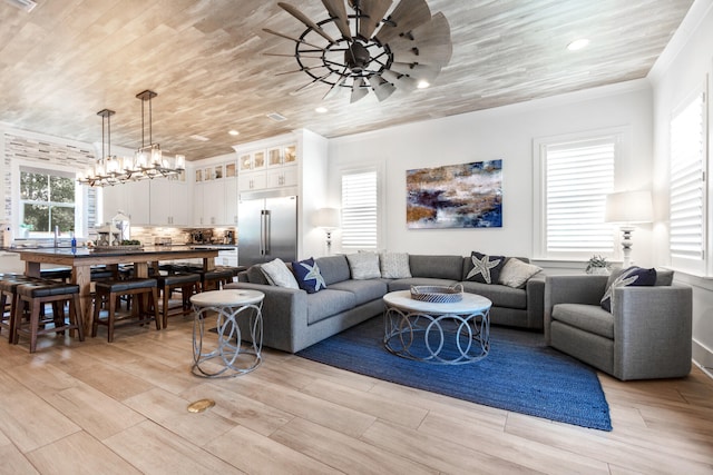 11 Wadleigh Way, Miramar Beach, FL 32550 - living area featuring ornamental molding, wooden ceiling, light wood-style floors, and ceiling fan with notable chandelier