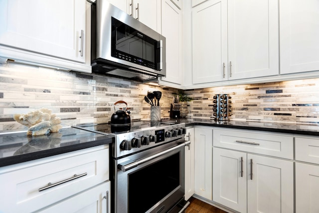 11 Wadleigh Way, Miramar Beach, FL 32550 - kitchen featuring appliances with stainless steel finishes, backsplash, and white cabinets