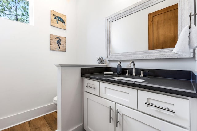 11 Wadleigh Way, Miramar Beach, FL 32550 - half bathroom featuring toilet, wood finished floors, vanity, and baseboards