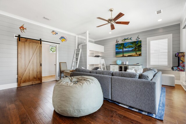 11 Wadleigh Way, Miramar Beach, FL 32550 - living room with radiator, visible vents, dark wood-style flooring, and a barn door