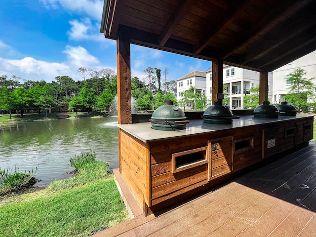 11 Wadleigh Way, Miramar Beach, FL 32550 - view of patio with exterior kitchen, a water view, and a grill