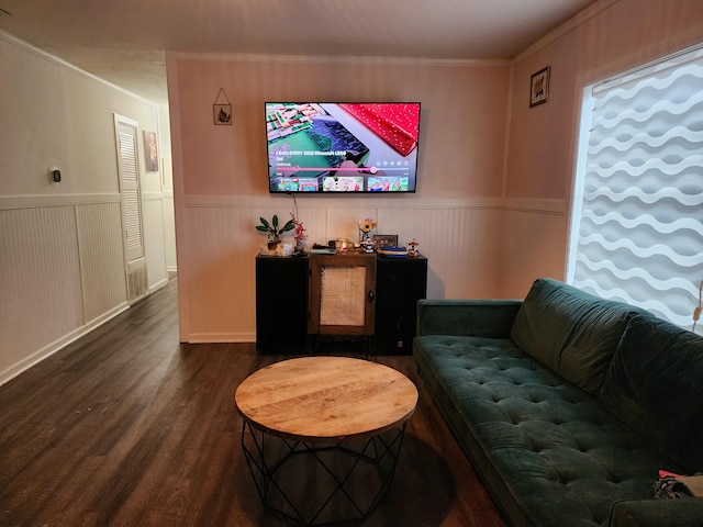 living room with dark wood-type flooring and crown molding