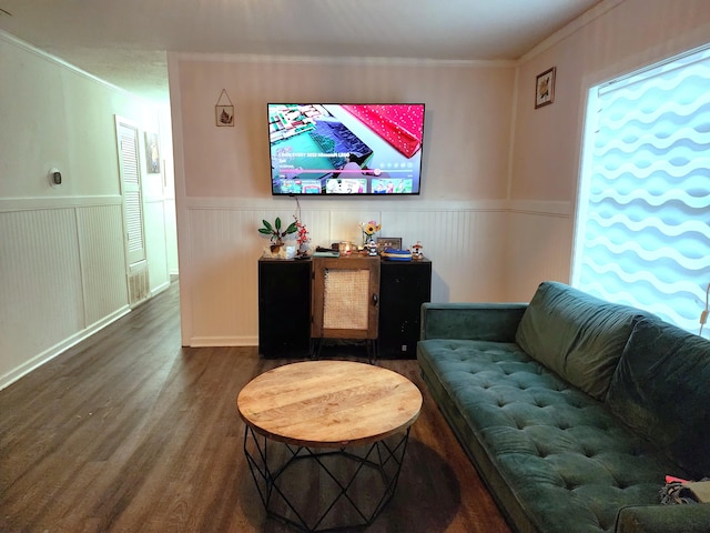 living room featuring dark hardwood / wood-style floors and crown molding