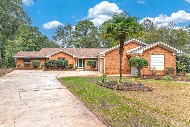 ranch-style home with a garage and a front yard