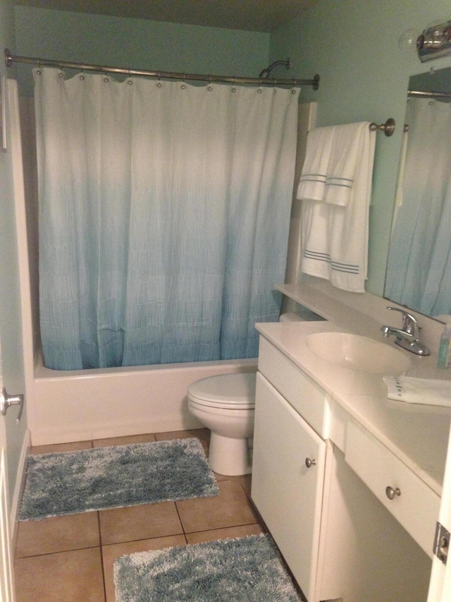 full bathroom featuring toilet, shower / tub combo, vanity, and tile patterned floors