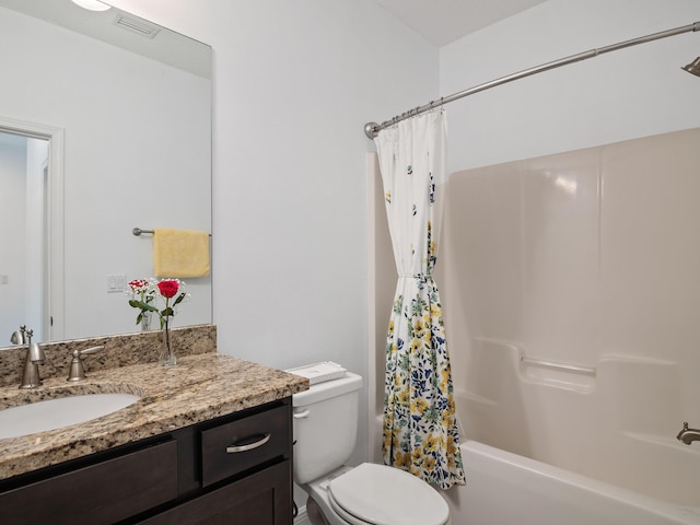 full bathroom with vanity, shower / bath combination with curtain, and toilet