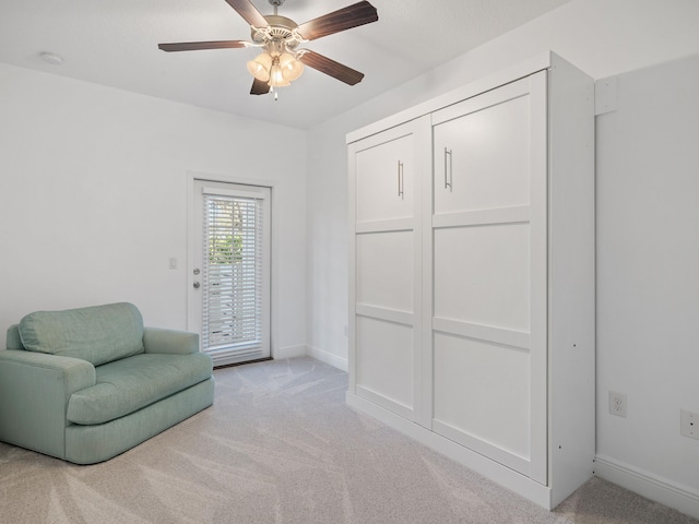 living area featuring ceiling fan and light colored carpet