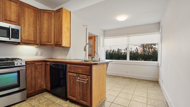 132 Circle Dr, Defuniak Springs, FL 32435 - kitchen featuring appliances with stainless steel finishes, sink, light tile patterned floors, and kitchen peninsula
