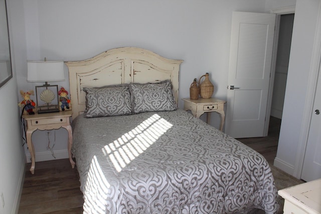 bedroom with dark hardwood / wood-style flooring