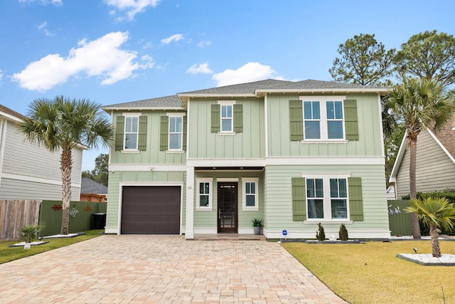 view of front of house with a garage and a front yard