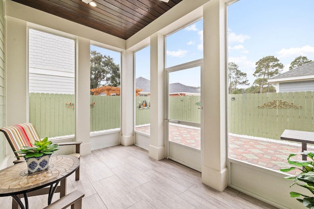 sunroom / solarium featuring wood ceiling