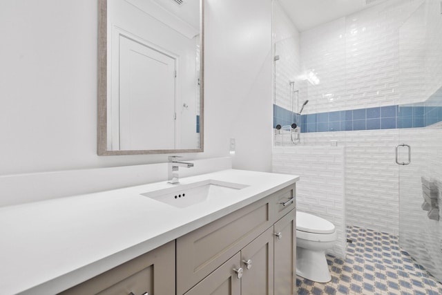 bathroom featuring vanity, toilet, and a shower with door