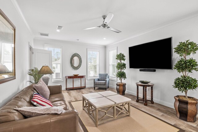 living room with ceiling fan, ornamental molding, and light hardwood / wood-style floors