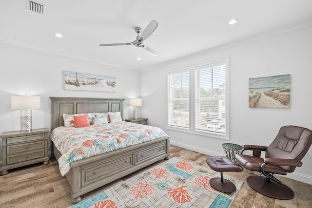 bedroom with crown molding, ceiling fan, and light wood-type flooring