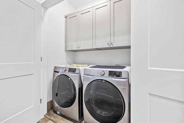 washroom featuring separate washer and dryer and cabinets