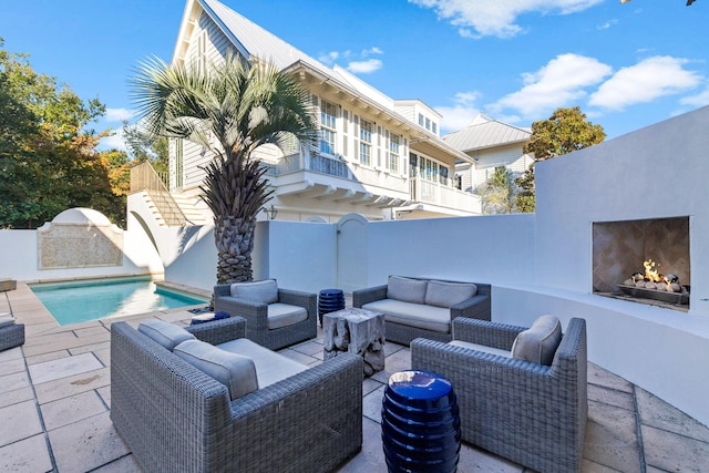 view of patio / terrace featuring an outdoor living space with a fireplace