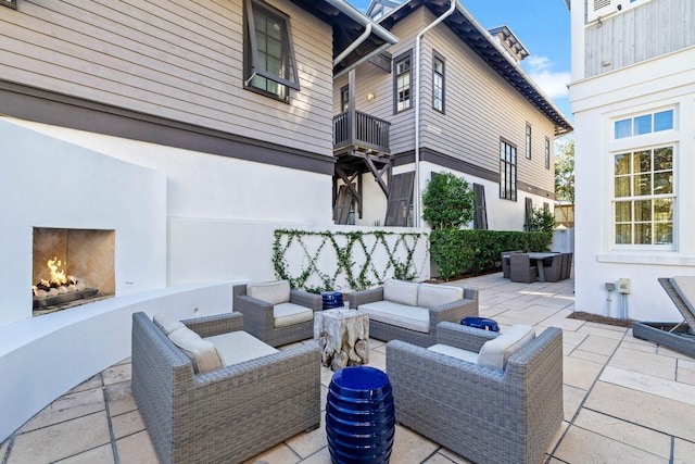 view of patio / terrace featuring exterior fireplace