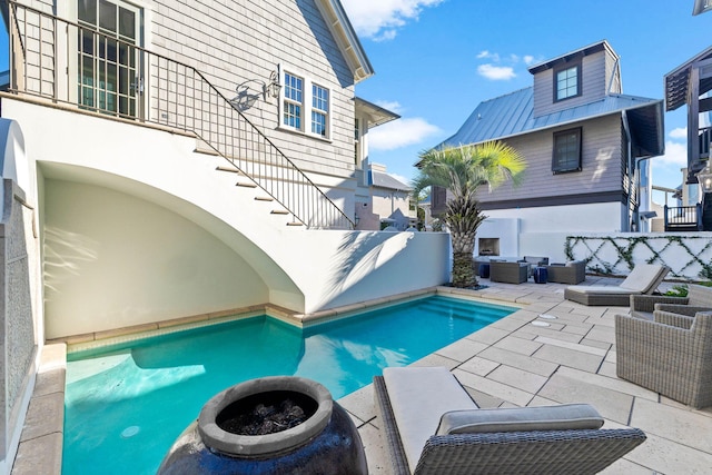 view of pool featuring an outdoor living space and a patio