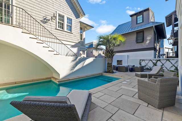 view of swimming pool with an outdoor living space and a patio