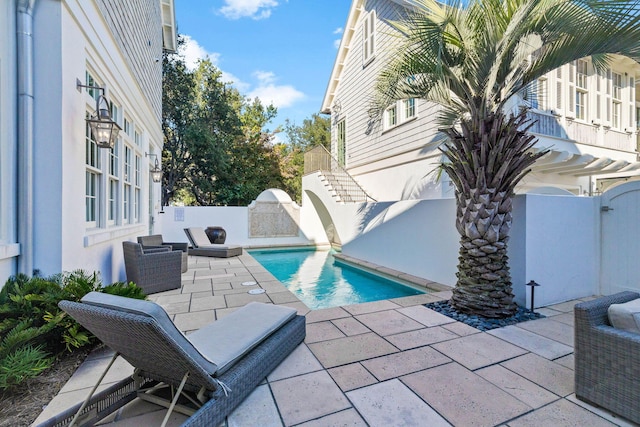 view of pool with a patio area and exterior kitchen