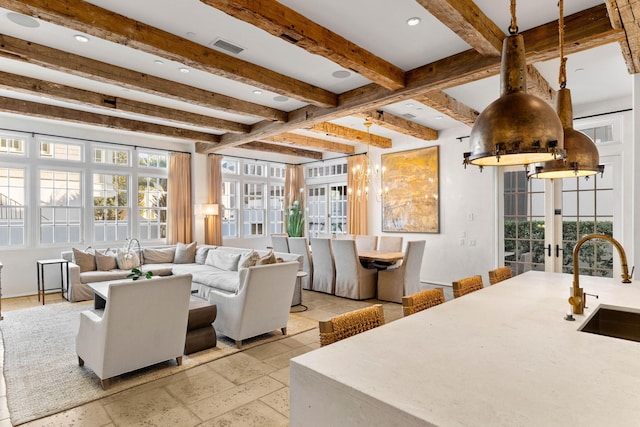 living room with beamed ceiling, french doors, and sink