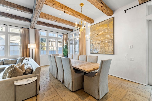 dining space with beam ceiling and a chandelier