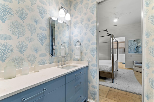 bathroom featuring wooden walls and vanity