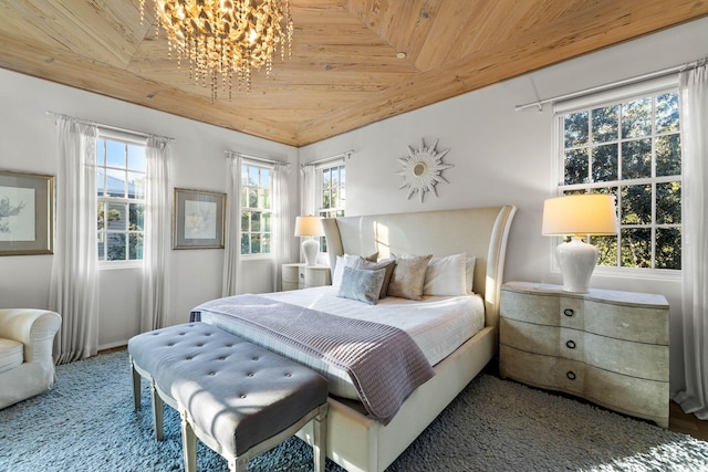 bedroom with multiple windows, a chandelier, and wood ceiling