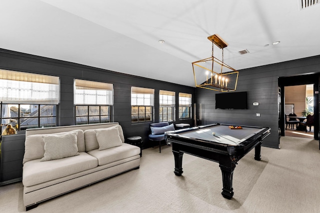 game room with light carpet, an inviting chandelier, wooden walls, and billiards