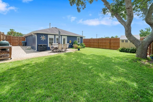 rear view of property with a patio and a lawn