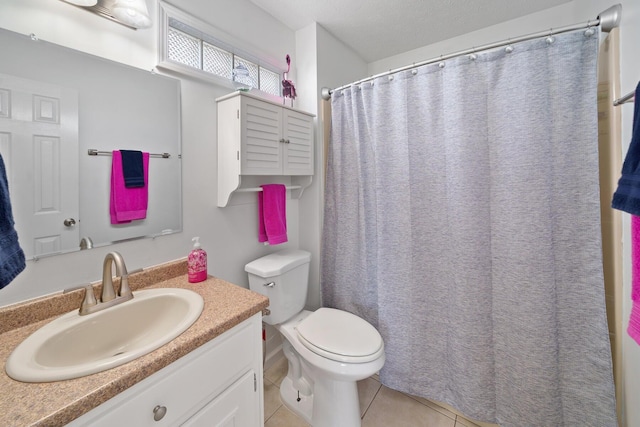 bathroom with tile patterned floors, vanity, and toilet