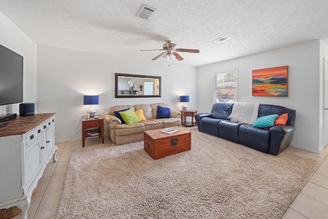 tiled living room featuring a textured ceiling and ceiling fan