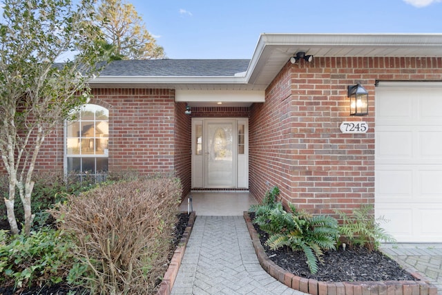 view of exterior entry with a garage