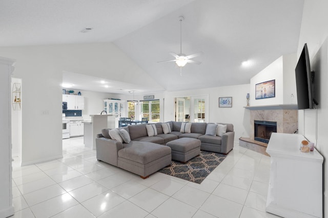 tiled living room featuring ceiling fan, high vaulted ceiling, and a fireplace