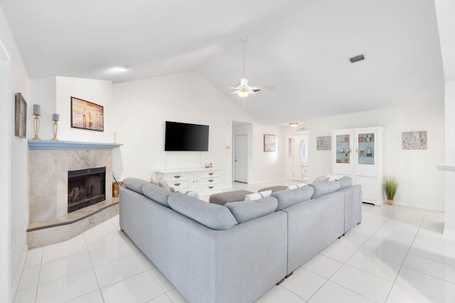 tiled living room featuring lofted ceiling, a fireplace, and ceiling fan