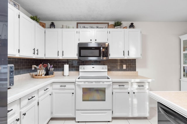 kitchen featuring white cabinetry, electric range, and backsplash