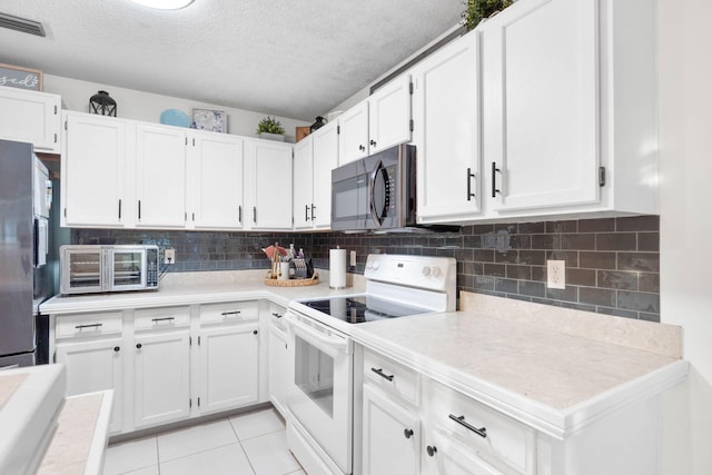 kitchen featuring white cabinetry, electric range, and light tile patterned floors