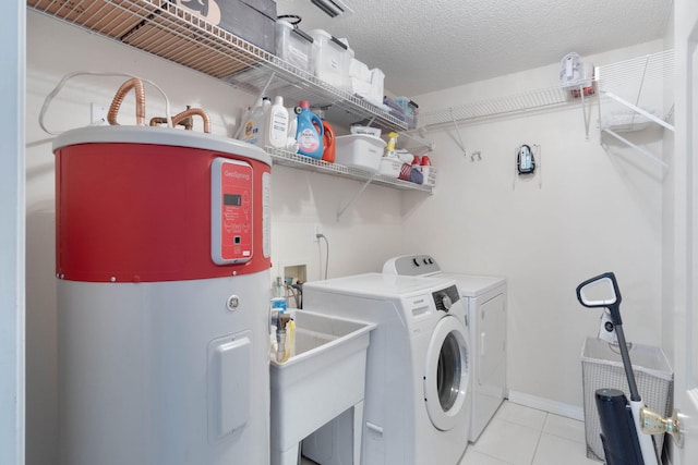 laundry room with light tile patterned floors, sink, water heater, a textured ceiling, and washing machine and clothes dryer