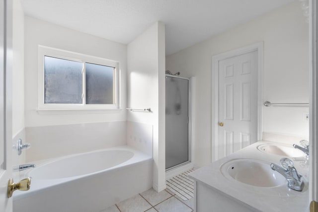 bathroom with tile patterned flooring, plus walk in shower, and vanity