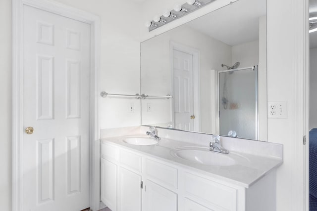 bathroom with an enclosed shower and vanity