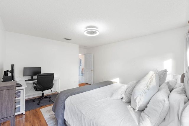 bedroom with hardwood / wood-style flooring