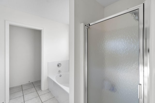 bathroom featuring tile patterned flooring and shower with separate bathtub