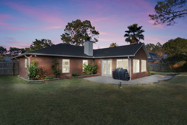 exterior space with a lawn, french doors, and a patio