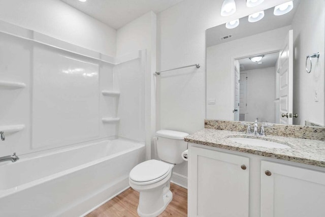 full bathroom with hardwood / wood-style flooring, vanity, toilet, and bathing tub / shower combination