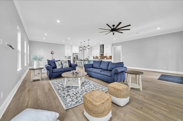 living room featuring ceiling fan and light hardwood / wood-style floors