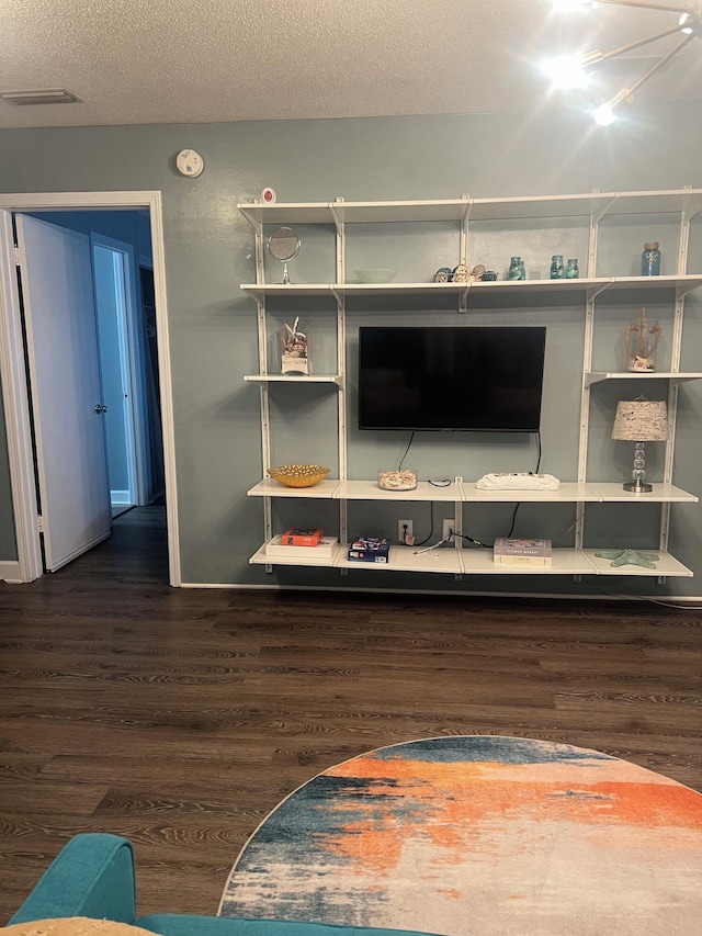 room details featuring a textured ceiling and hardwood / wood-style flooring