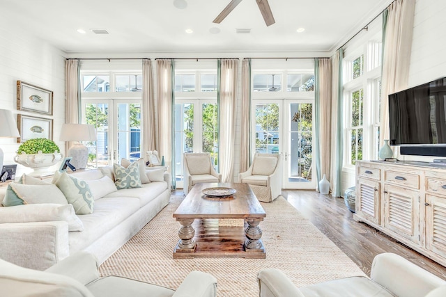 sunroom featuring ceiling fan and french doors