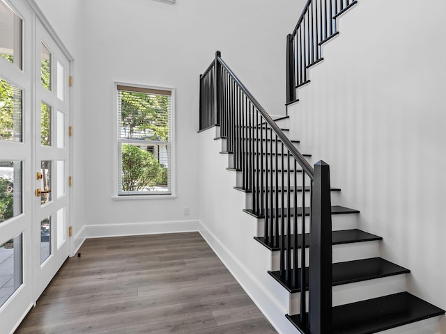 stairs with wood finished floors and baseboards