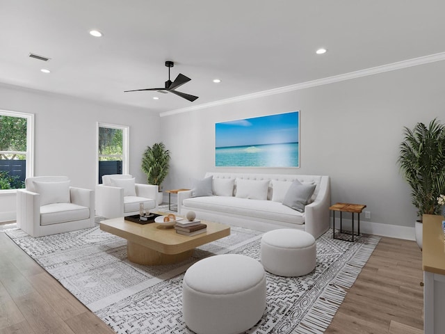 living room featuring hardwood / wood-style floors, ornamental molding, and ceiling fan