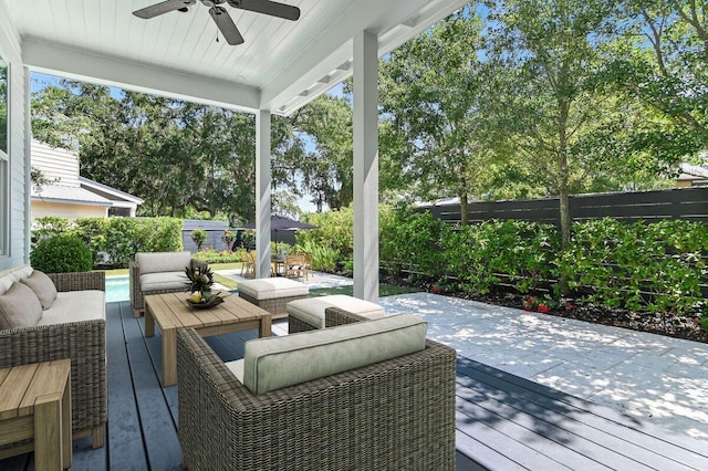 deck with an outdoor hangout area, fence, and a ceiling fan